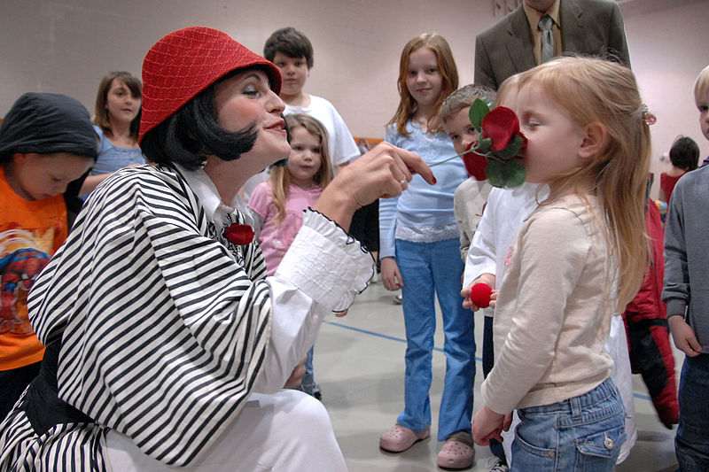 wikigirlsniffingflower.jpg